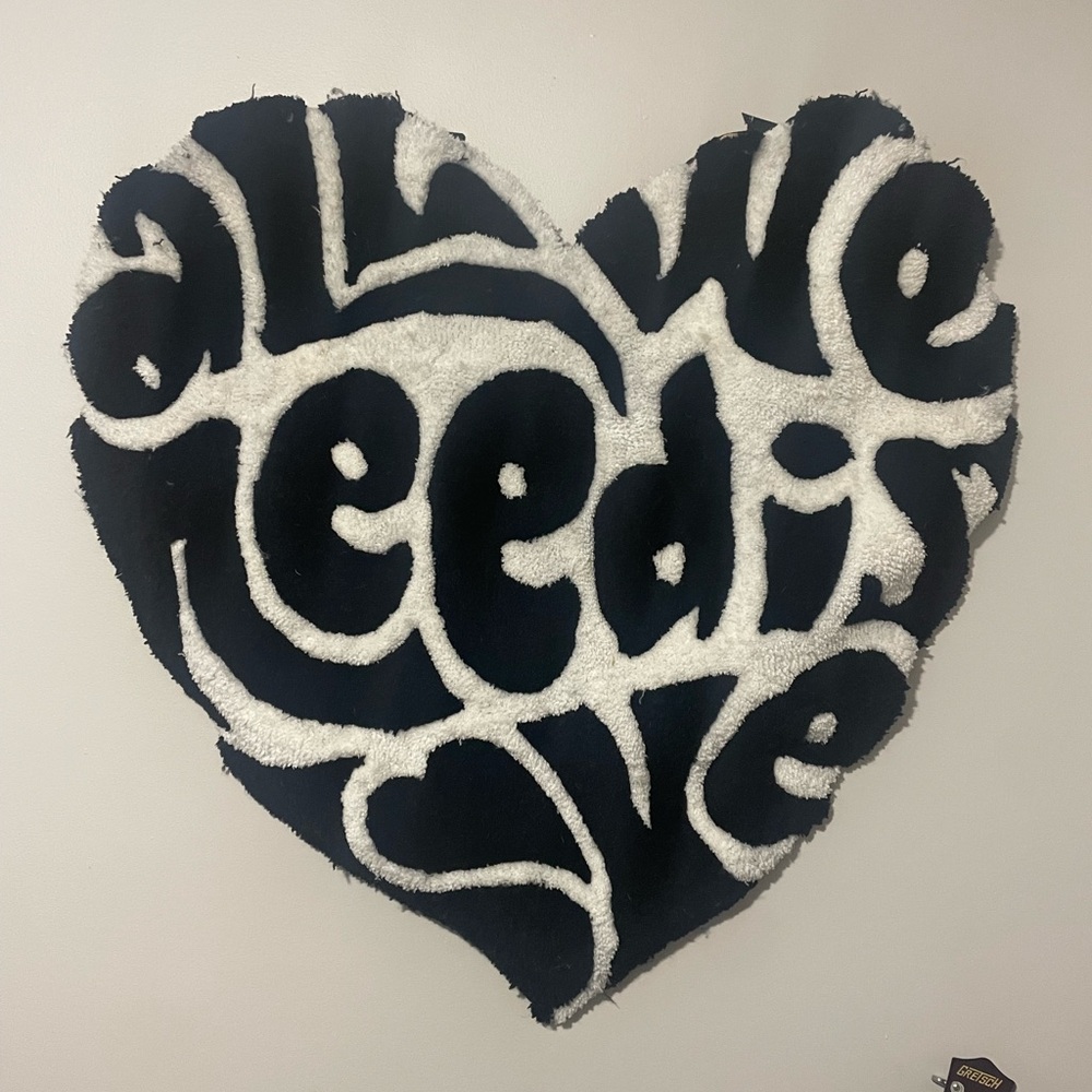 Hand-tufted “All we need is love” rug